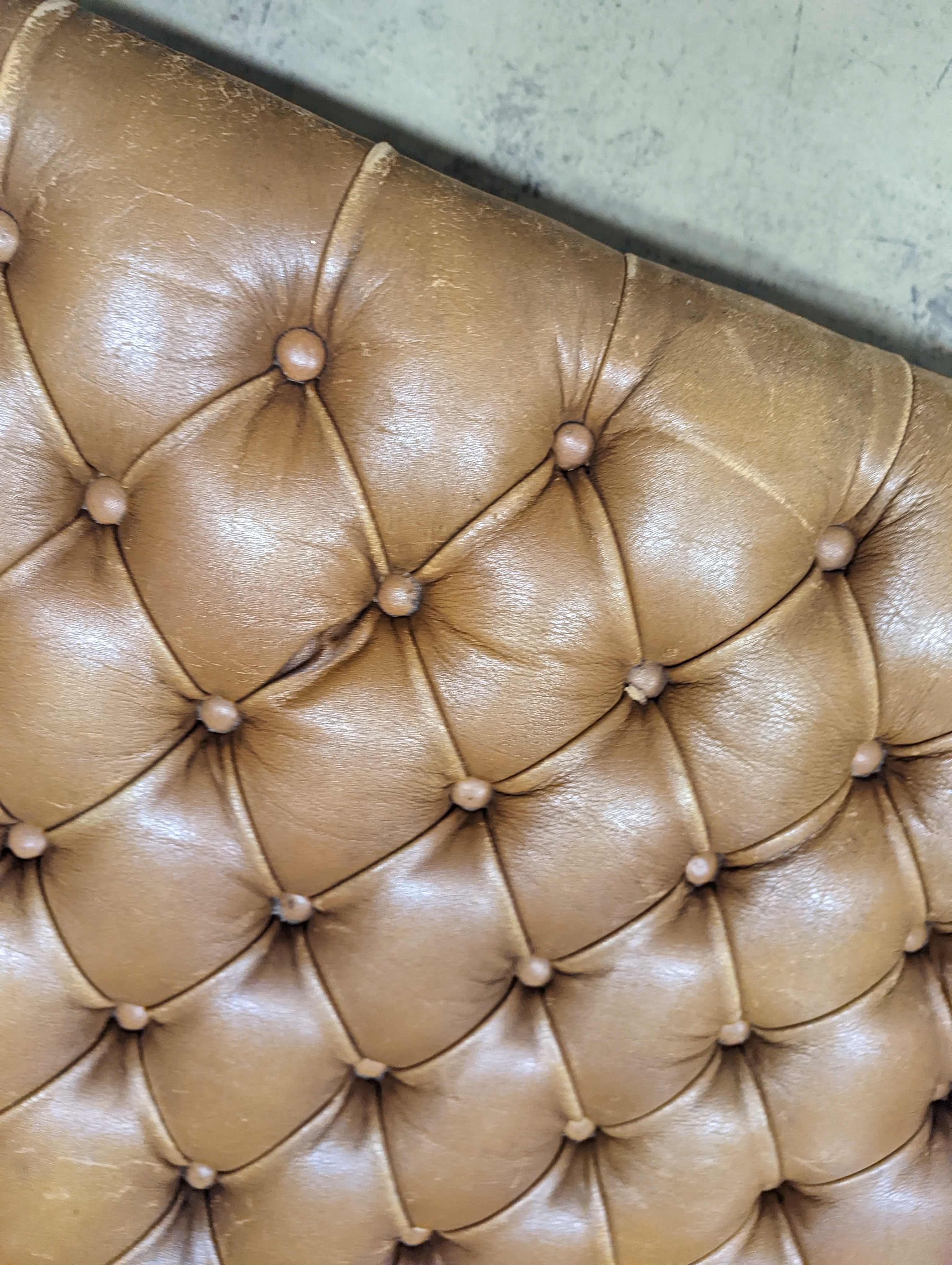 A Victorian carved X-framed rosewood footstool, upholstered in a buttoned brown leather, width 90cm depth 57cm height 42cm